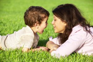 happy young mother playing with her son outdoor