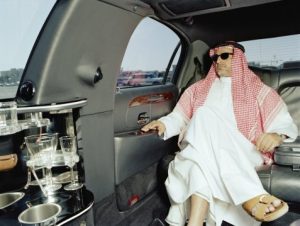 Man in traditional Arabic clothing in limousine