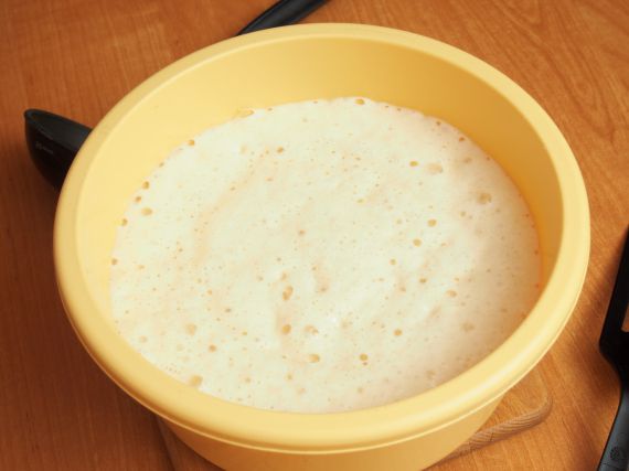 Yeast batter ready to fry. Making yeast pancakes (crepes).