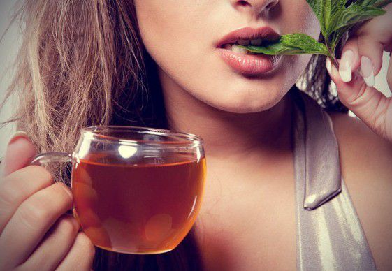 woman-biting-mint-leaves