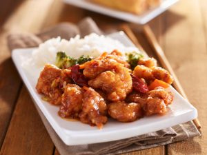 plate of chinese general tsos chicken with rice and broccoli